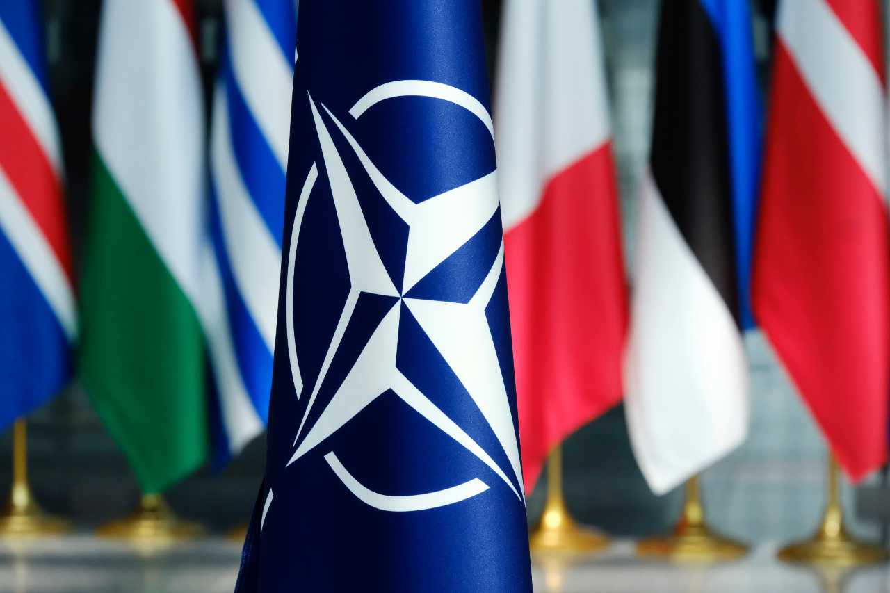 NATO Flag with Members flags in the background