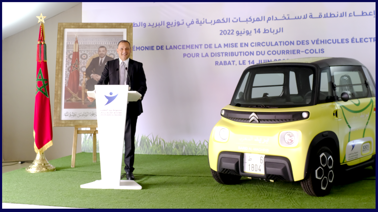 Minister of Industry in Morocco with an electric vehicle in the background