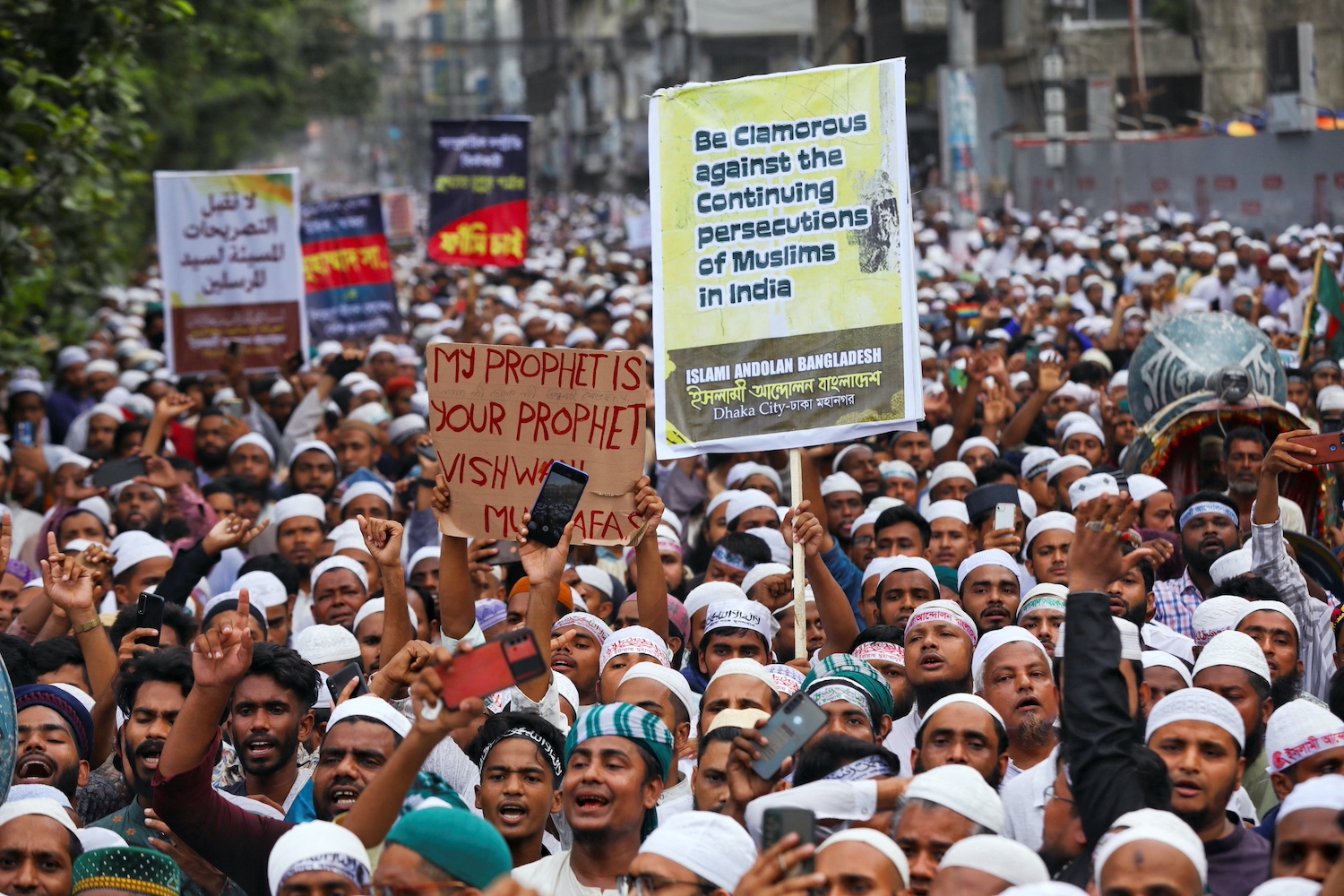 Muslims take part in a procession after Friday prayer to protest against the blasphemous comments on Prophet Mohammed by the members of the Indian Bharatiya Janata Party, in Dhaka